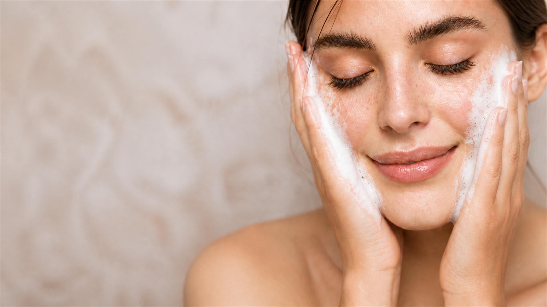 A woman gently washing her face, calm natural skin